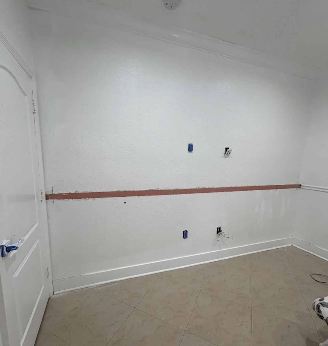 The same bedroom wall before, bare and unfinished